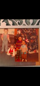 Two vintage photos of children in colorful outfits by a Christmas tree and on a floor.