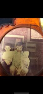 Vintage photo of a man holding two young children.