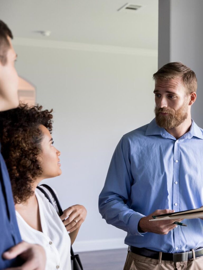 An insurance agent talking with a couple in CT.