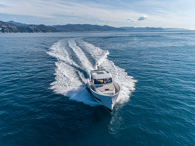 A sleek yacht speeds across a vast - https://brancoinsurancegroup.com/