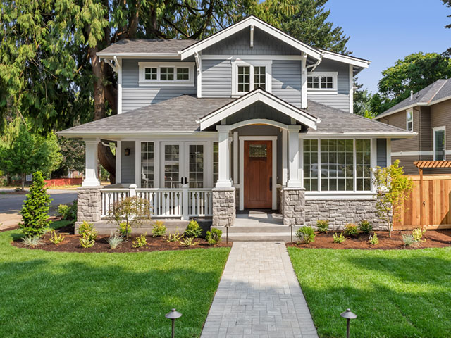 A charming, two-story house with gray siding - https://brancoinsurancegroup.com/
