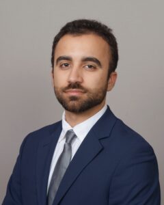 Young man in a suit with serious expression.