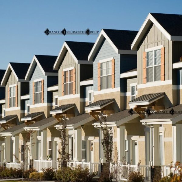 Row of modern townhouses under clear sky.